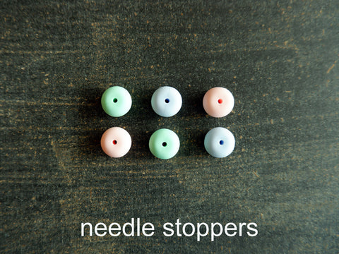 Point Protectors or needle stoppers for knitting needles.